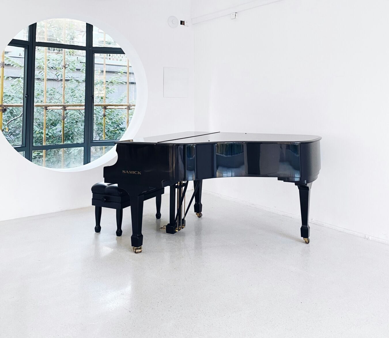 Black grand piano in a white room
