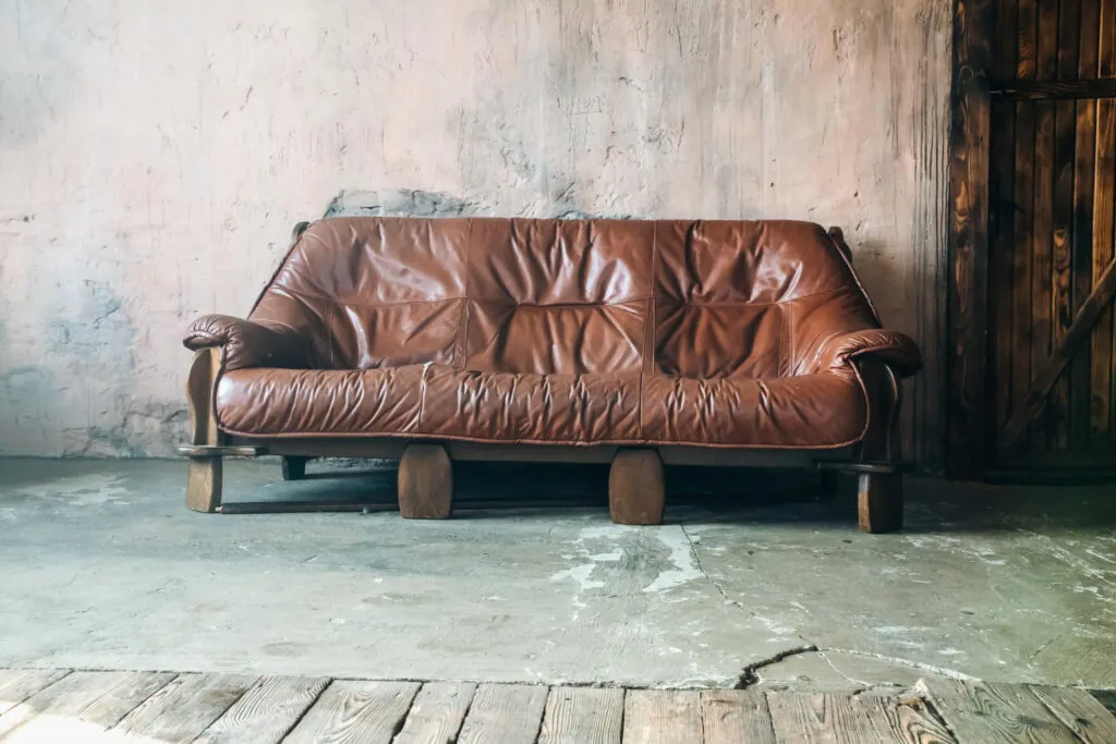 Old Brown leather sofa in loft design apartment