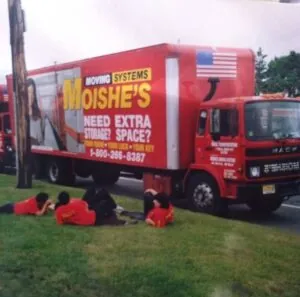 Movers on lawn with a truck