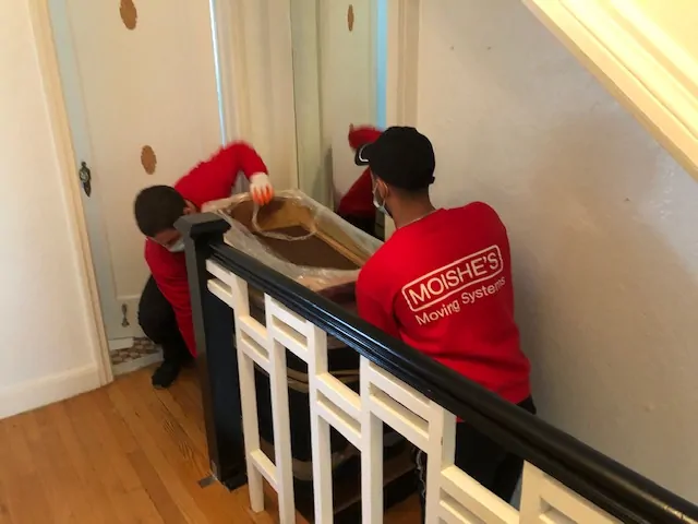 Moishe's movers carrying furniture in NYC