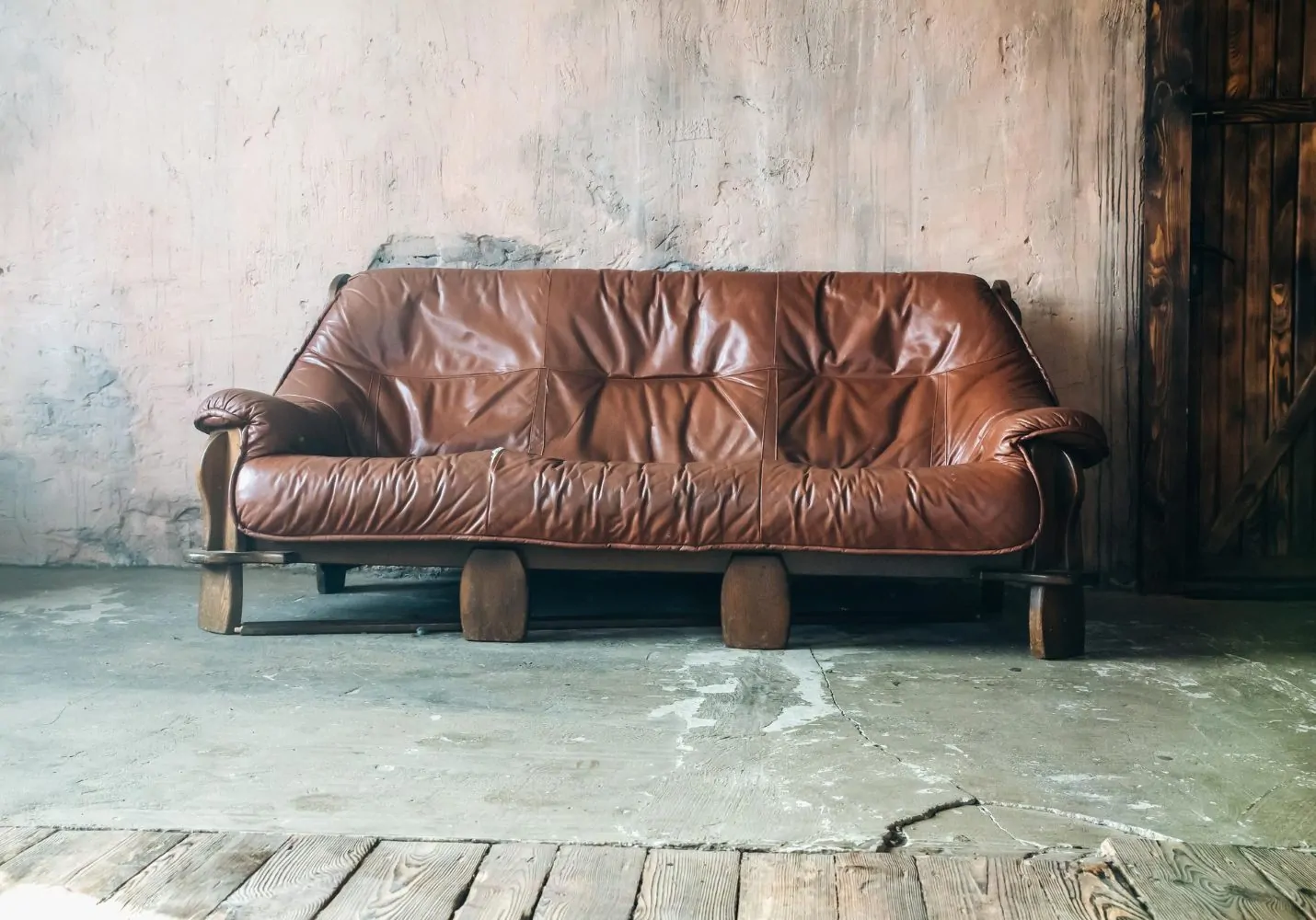 Old Brown leather sofa in loft design apartment