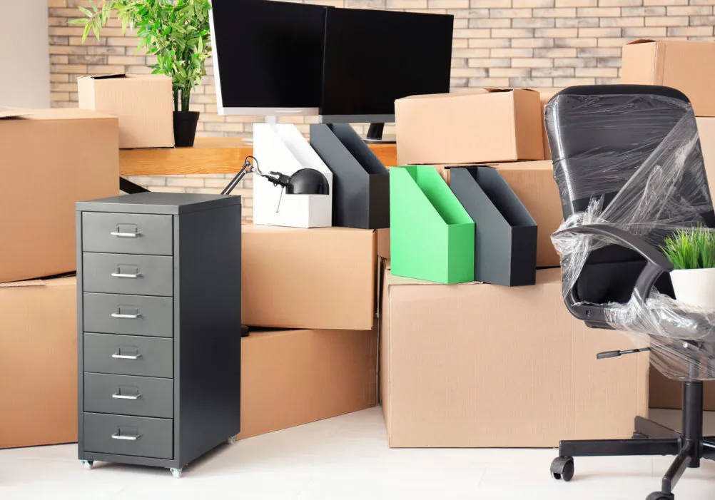 Carton boxes with stuff in empty room. Office move concept